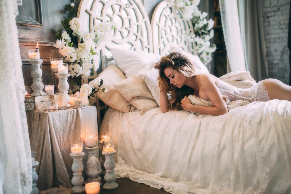 Woman Posing In White Dress On Bed